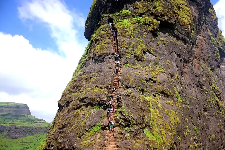 The near-vertical rock-cut staircase of Harihar Fort climbing a sheer basalt face near Nashik